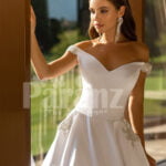 Beautiful metal white off-shoulder tulle underneath Cinderella wedding gown close view