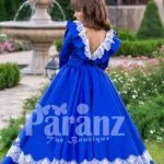 Bright royal blue full sleeve floor length rich satin dress with detail white lace work back side view