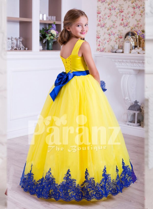 Bright yellow sleeveless floor length tulle skirt party gown with royal blue lace works back side view