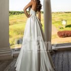 Closed neck and open back flared satin wedding gown with tulle skirt underneath back side view