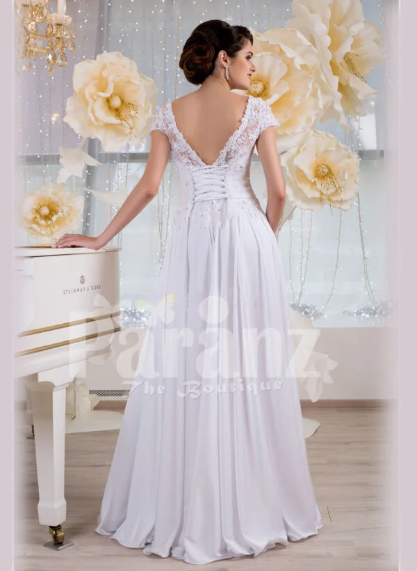 Elegant all white lacy bodice wedding gown with floor length tulle skirt Back side view