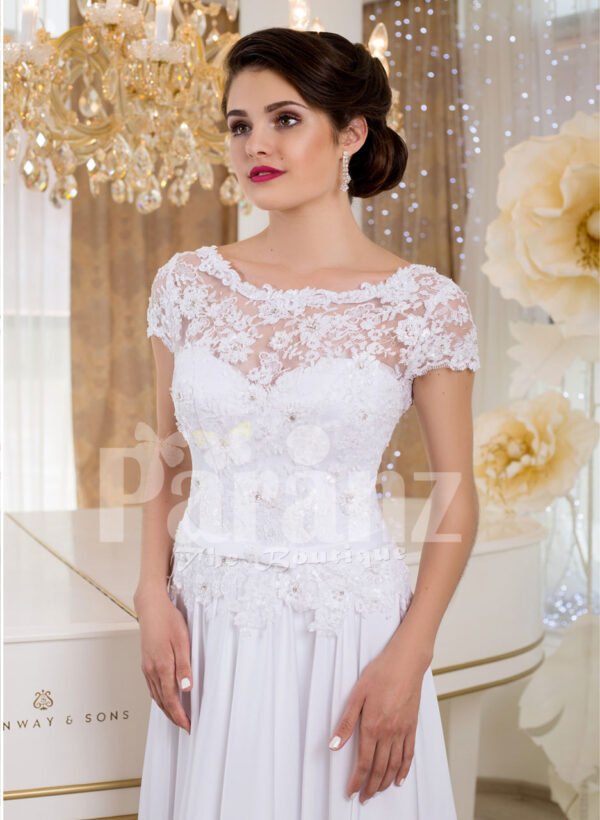 Elegant all white lacy bodice wedding gown with floor length tulle skirt Close view