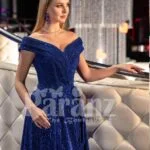 Elegant blue glitz evening gown with off-shoulder bodice and side slit skirt