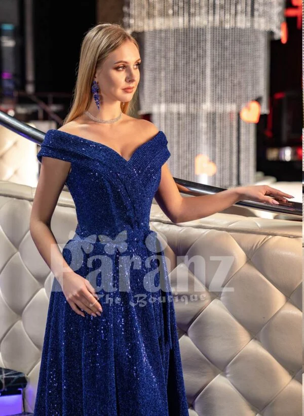 Elegant blue glitz evening gown with off-shoulder bodice and side slit skirt