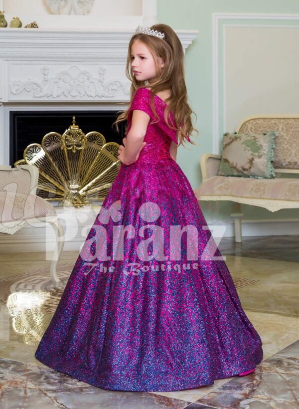 Elegant magenta pink floor length baby gown with all over blue glitz and royal bodice side view