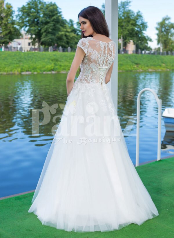 Elegant pearl white floor length flared tulle skirt wedding gown with lacy bodice back side view