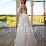 Elegant white soft tulle skirt wedding gown with full sleeve royal bodice back side view