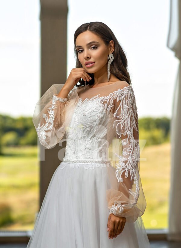 Elegant white soft tulle skirt wedding gown with full sleeve royal bodice close view