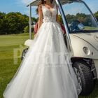 Flared and long tulle pearl white wedding gown with lacy bodice