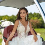 Flared and long tulle pearl white wedding gown with lacy bodice close view