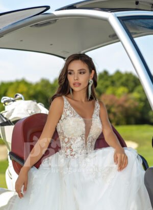 Flared and long tulle pearl white wedding gown with lacy bodice close view