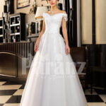 Floor length pearl white off-shoulder satin gown with high volume tulle skirt