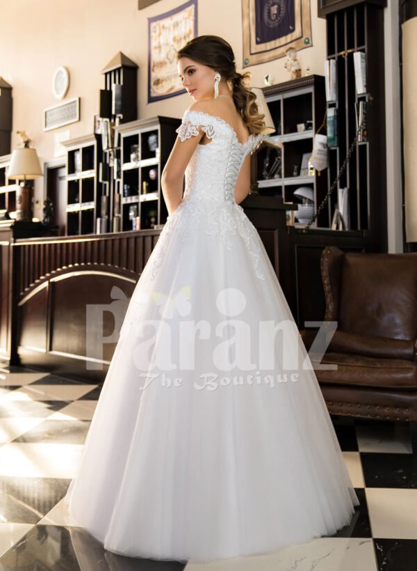 Floor length pearl white off-shoulder satin gown with high volume tulle skirt back side view