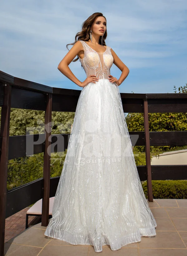 Floor length pearl white tulle wedding gown with glam sheer bodice