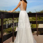 Floor length pearl white tulle wedding gown with glam sheer bodice back side view