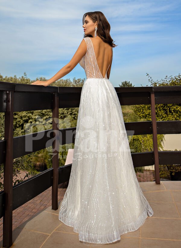 Floor length pearl white tulle wedding gown with glam sheer bodice back side view