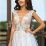 Floor length pearl white tulle wedding gown with glam sheer bodice close view