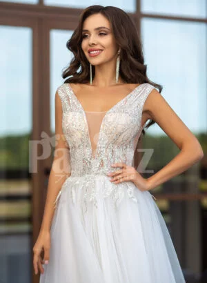 Floor length pearl white tulle wedding gown with glam sheer bodice close view