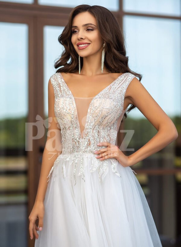 Floor length pearl white tulle wedding gown with glam sheer bodice close view