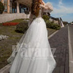 Floor length white tulle skirt gown with Arabic princess sleeves and bodice back side view