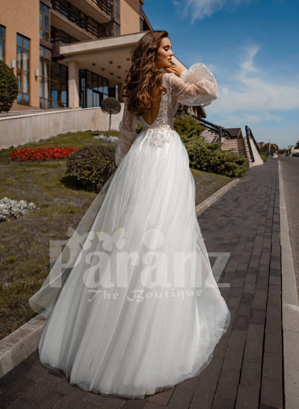 Floor length white tulle skirt gown with Arabic princess sleeves and bodice back side view