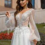 Floor length white tulle skirt gown with Arabic princess sleeves and bodice close view