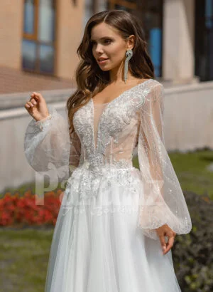 Floor length white tulle skirt gown with Arabic princess sleeves and bodice close view