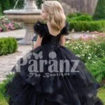 Glam black floor length multi-layer tulle skirt gown with white floral work elite bodice back side view