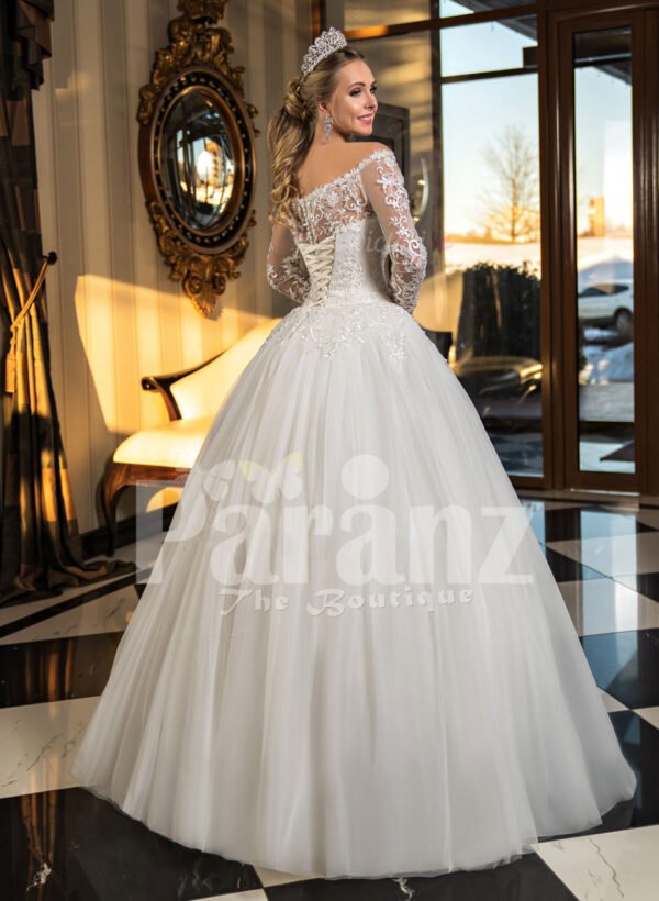 High volume tulle skirt wedding gown with full sleeve royal bodice in white back side view