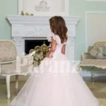 Light pink baby gown with flared and high volume tulle skirt and brown floral appliquéd bodice side view