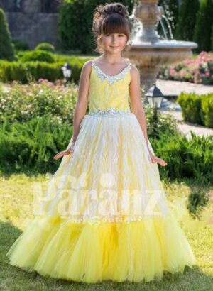 Light yellow sleeveless baby gown with rhinestone neckline and floor length tulle skirt