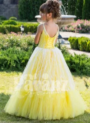 Light yellow sleeveless baby gown with rhinestone neckline and floor length tulle skirt back side view