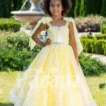 Light yellow sleeveless baby party gown with flared and floor length tulle skirt