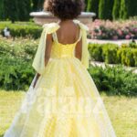 Light yellow sleeveless baby party gown with flared and floor length tulle skirt back side view