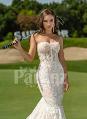 Mermaid style flared trail tulle wedding gown with rich lace work close view