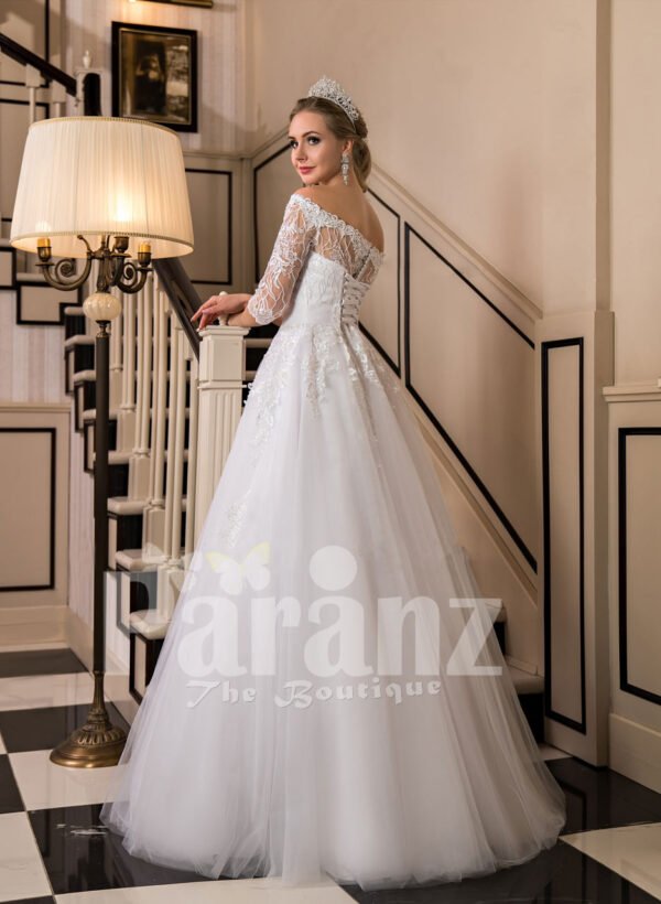 Off-shoulder pearl white floor length flared wedding tulle gown side view