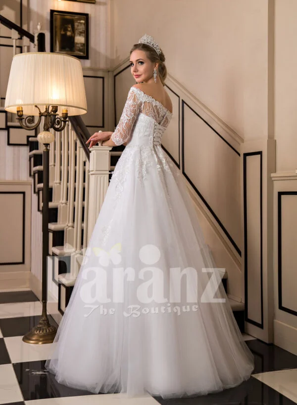 Off-shoulder pearl white floor length flared wedding tulle gown side view