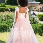 Peach pink unique sleeveless baby gown with flared tulle skirt and sheer overskirt back side view