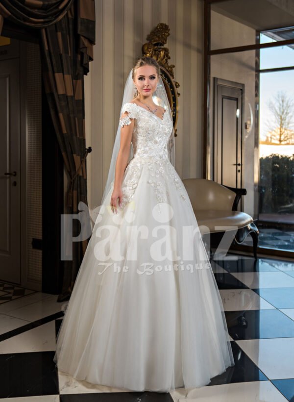 Pearl white cap sleeve floor length tulle wedding gown with floral bodice