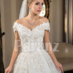 Pearl white cap sleeve floor length tulle wedding gown with floral bodice Close view