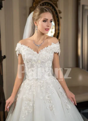 Pearl white cap sleeve floor length tulle wedding gown with floral bodice Close view