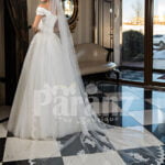 Pearl white cap sleeve floor length tulle wedding gown with floral bodice back side view
