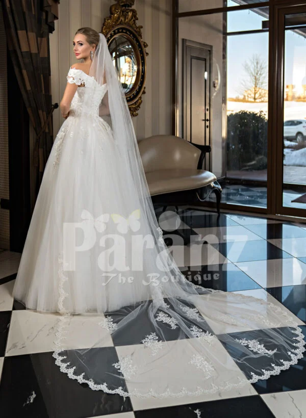 Pearl white cap sleeve floor length tulle wedding gown with floral bodice back side view