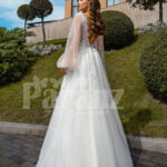 Pearl white glam tulle wedding gown with royal bodice and sleeves back side view