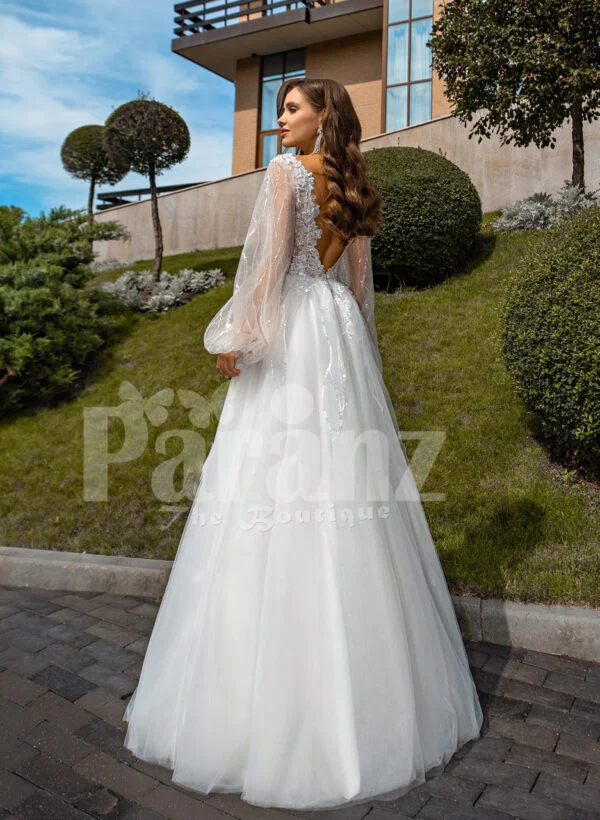 Pearl white glam tulle wedding gown with royal bodice and sleeves back side view