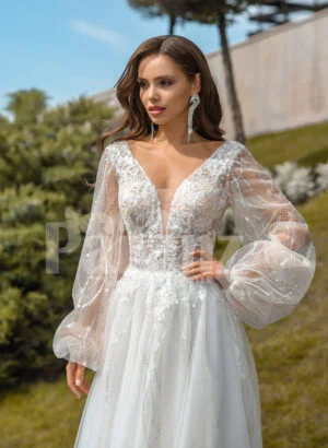 Pearl white glam tulle wedding gown with royal bodice and sleeves close view