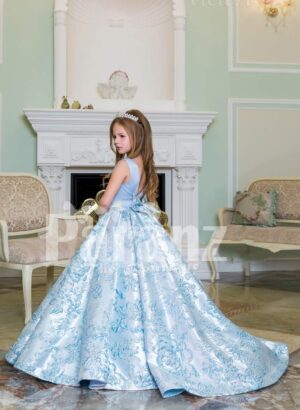Rich satin shiny floor length baby gown with all over same hue floral appliqués in blue side view