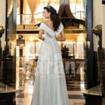 Side slit floor length off-shoulder white glitz wedding gown for women back side view