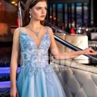 Sleeveless elegant blue evening gown with side slit tulle skirt and floral appliquéd royal bodice