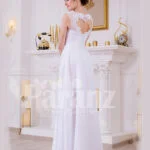 Sleeveless pearl white floor length tulle skirt wedding gown with lace appliquéd bodice back side view